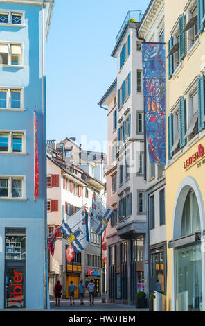 Zürich, Schweiz - 10. Juli 2016: Eine Gasse der Altstadt mit Fahnen und Passanten Stockfoto