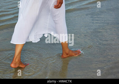 Frau barfuß waten im Ozean Stockfoto