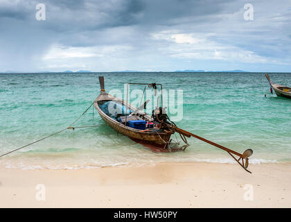 Thailand, Provinz Krabi. Fischerdorf auf einer der vielen Inseln im Meer. Angeln Longtail Boote vertäut am Strand. Stockfoto