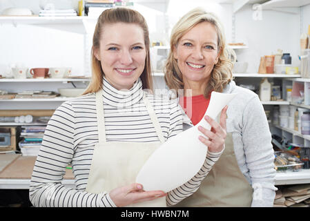 Reife Frau mit Blick auf Vase aus Keramik-Klasse Lehrer Stockfoto
