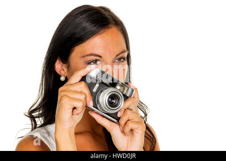 Eine junge Frau nimmt ein Foto der Kamera mit einem Retro, Eine Junge Frau bei Mit Einer Retro-Kamera Stockfoto