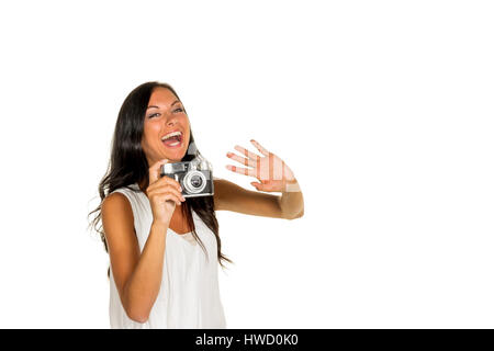 Eine junge Frau nimmt ein Foto der Kamera mit einem Retro, Eine Junge Frau bei Mit Einer Retro-Kamera Stockfoto