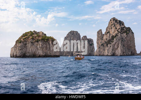 Capri, Italien - 31. August 2016: Touristen eine Bootsfahrt zur berühmten Faraglioni Felsen an Capri Küste Stockfoto