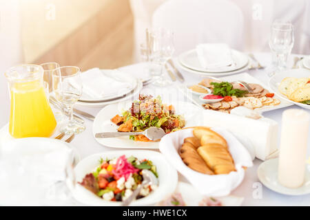 Tisch im Restaurant essen. Leckere Vorspeisen, Salate. Verschiedene Gerichte für die Gäste auf der Hochzeitstisch Stockfoto