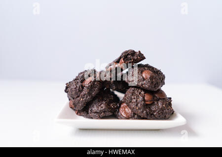 Stack vegane Schokolade Brownie Cookies auf weiße quadratische Platte Stockfoto