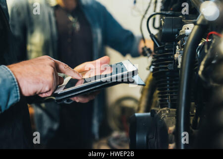 Zwei reife Männer, in Garage, arbeiten mit digital-Tablette, close-up Stockfoto