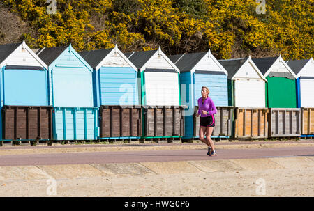 Bournemouth, Dorset, UK. 21. März 2017. UK-Wetter: Bournemouth genießt einen schönen sonnigen Tag als Besucher gehen ans Meer machen das Beste aus der Sonne an den Stränden von Bournemouth. Frau Joggen entlang der Promenade Vergangenheit Strandhütten Credit: Carolyn Jenkins/Alamy Live News Stockfoto