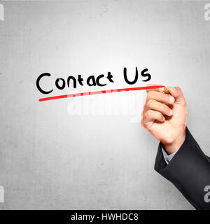 Mann mit Stift schreiben Kontakt Text über Grunge Hintergrund Stockfoto