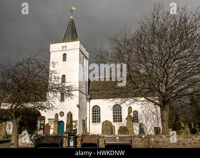 Weiß getünchte alte Yester Parish Church in Gifford, East Lothian, Schottland, Großbritannien mit launisch dunklen stürmischen Himmel Stockfoto