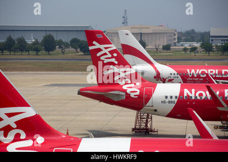 BANGKOK, THAILAND - 3. März 2014: Ausladen des Gepäcks vom Flugzeug Air Asia in Bangkok Flughafen. Air Asia Company ist die größte low-cost Fluglin Stockfoto