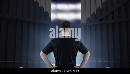 Rugby-Spieler mit den Händen auf den Hüften gegen Fußballplatz mit World Cup flags 3d Stockfoto