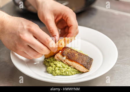 Koch ist zum Abendessen im Restaurantküche kochen. Stockfoto