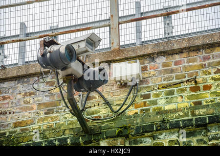 Eine Überwachungskamera an einer Mauer befestigt wacht über Menschen in Shepherds Bush Market in London Stockfoto