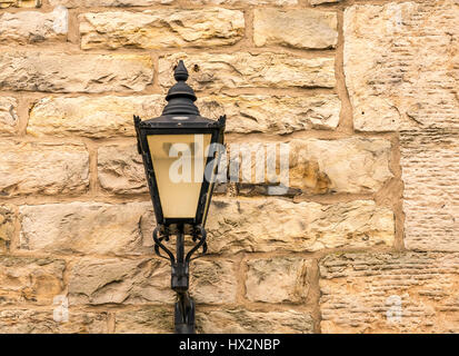 Nahaufnahme der altmodischen verzierten viktorianischen Straßenleuchte an der Sandsteinwand, Edinburgh, Schottland, Großbritannien Stockfoto