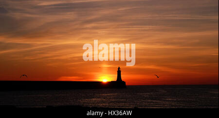 Die Sonne geht über Tynemouth Leuchtturm in Tyne and Wear am letzten Tag bevor die Uhren vorwärts zu gehen. Stockfoto