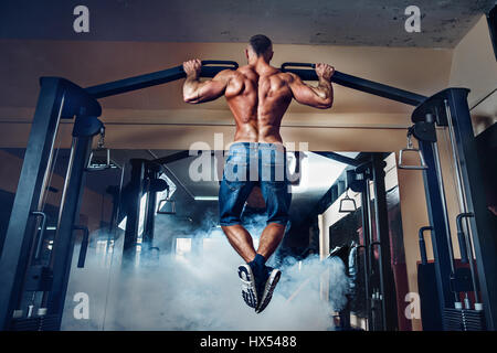 Junge Sportler auf Balken im Fitness-Studio trainieren Stockfoto