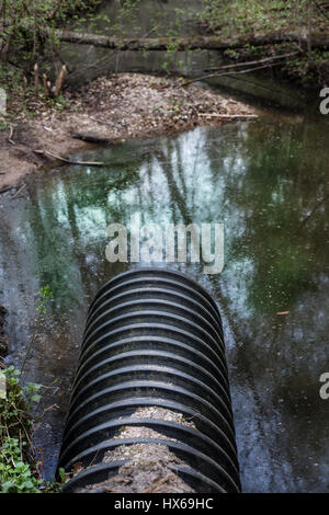 Schmutziges Wasser ergibt sich aus dem Rohr, die Verschmutzung des Flusses Stockfoto