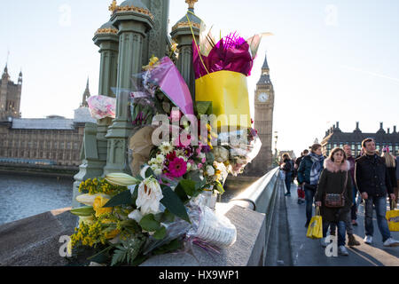 London, UK. 25. März 2017. Fußgänger untersuchen Frühlingsblumen und Nachrichten auf Westminster Bridge in Gedenken an die Opfer von Terror-Anschlag auf Westminster am 22. März angeordnet. Bildnachweis: Mark Kerrison/Alamy Live-Nachrichten Stockfoto