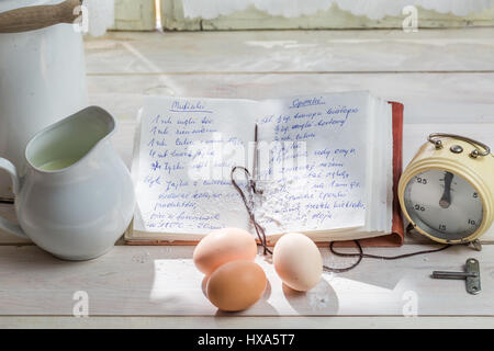 Zutaten und Kochbuch zum Backen auf alten weißen Tisch Stockfoto