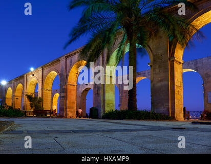 Die Nachtansicht terrassenförmig angelegten Bögen und die Palme in der Upper Barrakka Gardens, Valletta, Malta Stockfoto