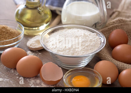 Eiern und Mehl Grundzutaten für das Backen auf Holztisch Hintergrund Stockfoto