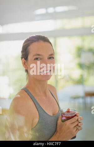 Porträt lächelnde Frau trinken Saft smoothie Stockfoto