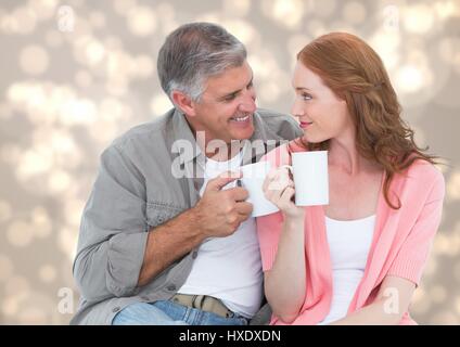Digitalen Verbund von Mann und Frau mit weißen Tassen gegen Creme bokeh Stockfoto