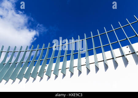 Metallzaun auf moderne weiße Brücke Struktur unter blauen Wolkenhimmel Stockfoto