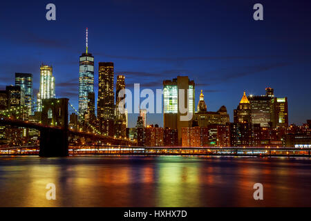 New York Citys Brooklyn Bridge und die Skyline von Manhattan bei Nacht beleuchtet Stockfoto