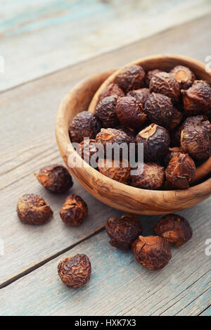 Waschnüsse in Schüssel auf hölzernen Hintergrund closeup Stockfoto