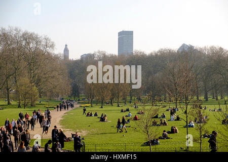 An einem warmen, sonnigen Tag im März sind Menschen in Green Park London genießen die Sonne Stockfoto