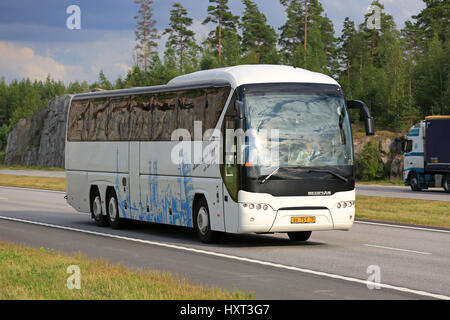 PAIMIO, Finnland - 19. August 2016: White Neoplan Tourliner Reisebus bewegt sich entlang der Autobahnverkehr in die ländliche Landschaft südlich von Finnland. Stockfoto