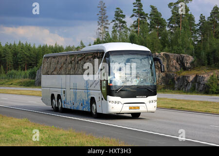 PAIMIO, Finnland - 19. August 2016: White Neoplan Tourliner Reisebus bewegt sich entlang der Autobahn in die ländliche Landschaft südlich von Finnland. Stockfoto