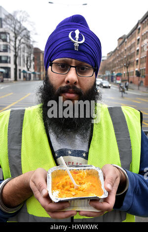 Sikh freiwillige Aushändigung Curry für Wohnungslose in Cardiff. Mitglieder des Vereins Midland Langar Seva sind abgebildet Stockfoto