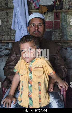 21. Dezember 2016 - Cox Bazar, Chittagong, Bangladesch - Caption: Teknaf, Chittagong, Bangladesch: MIZANUR, die Rohingya-Flüchtlinge besitzen, für ein Foto. Er verließ Rakhine-Staat von Myanmar wo religiös motivierter Gewalt Tok Agianst die Rohingya der muslimischen Minderheit im Oktober 2016 mit seinem Sohn und Frau platzieren. Jetzt leben sie ihr Leben in einem nicht registrierten Flüchtlingslager wie neue Flüchtlinge sind nicht immer die Möglichkeit, als Bewohner von Bangladesch registriert werden. Bildnachweis: Debsuddha Banerjee/ZUMA Draht/Alamy Live-Nachrichten Stockfoto