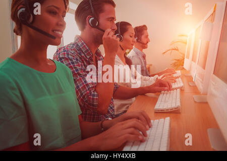 Business-Team gemeinsam an ein Call-Center-Headsets tragen Stockfoto