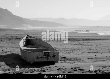 Schwarz weißes Bild eines Bootes am Ufer Meeres, nach dem Sturm Stockfoto