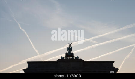 Die aufgehende Sonne Silhouetten am Brandenburger Tor in Berlin, Mitteldeutschland, 2. April 2017. Foto: Paul Zinken/dpa Stockfoto