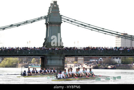 Oxford Herren Crew (links) übernehmen die Führung gegen Cambridge (rechts) bei den Herren Boat Race auf der Themse, London. Stockfoto