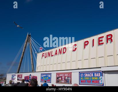 Funland Arcade aufbauend auf Southport Pier mit Marine Art Hängebrücke im Hintergrund Stockfoto