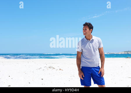 Porträt von einem gut aussehenden Mann mittleren Alters lächelnd am Strand Stockfoto