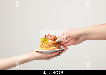 Nahaufnahme der Kuchen mit frischen Früchten auf grauem Hintergrund. Stockfoto