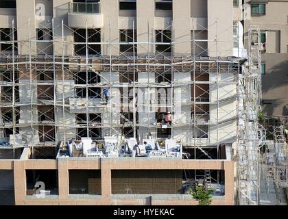 KAOHSIUNG, TAIWAN--18. April 2015: Bauarbeiter arbeiten an der Fassade eines Neubaus der Wohnung in der Stadt. Stockfoto