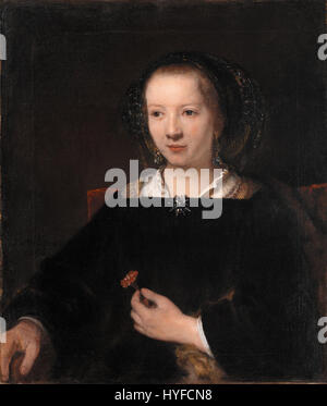 Junge Frau mit Nelke ist ein Gemälde, das der Werkstatt des niederländischen Künstlers Rembrandt van Rijn (1606–1669) zugeschrieben wird. Es stellt eine junge Frau dar, die eine Nelke hält, was Rembrandts Einfluss und die Arbeit seines Ateliers veranschaulicht. Stockfoto