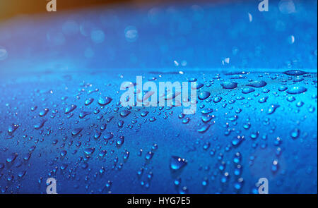 Wassertropfen auf Metall blau Autolack. Nahaufnahme der Regen fällt auf blauen Oberfläche Stockfoto