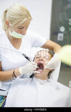Patient und ihr Zahnarzt, eine umfassende Prüfung auf regelmäßigen Checkup bei Zahnarztpraxis, Karies und Parodontitis werden gesucht. Mündliche hygi Stockfoto