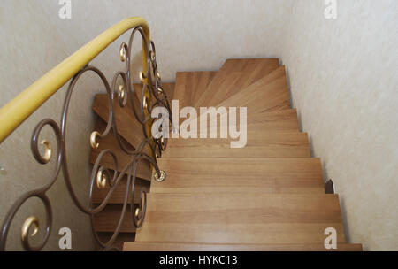 Metallische Beige String - ein Entwurf für den Bau der Treppe im Haus. Holztreppen und Geländer Metall Maßwerk geschmiedet. Stockfoto