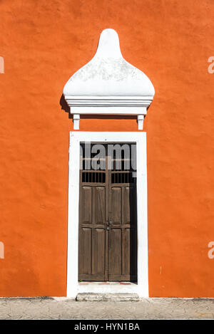 Alte Holztür auf einem orange koloniale Gebäude im historischen Zentrum von Valladolid, Mexiko Stockfoto