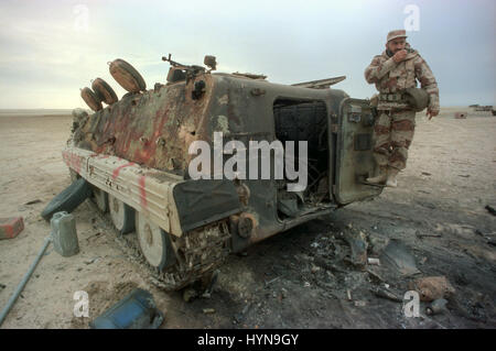 Qatari Soldat inspiziert eine irakische Schützenpanzer durch US-Flugzeuge nach der Schlacht von Khafji 2. Februar 1991 in Saudi Arabien Khafji Stadt, zerstört. Schlacht von Khafji war das erste große Boden-Engagement des Golf-Krieges. Stockfoto