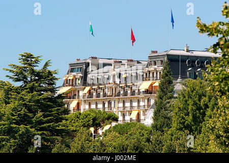 Beau-Rivage Palace Hotelgebäude mit Flaggen am Genfer See promenade, Fischerdorf Ouchy, Lausanne, Schweiz Stockfoto